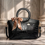Valencia croc-embossed leather satchel with top handles and crossbody strap