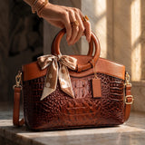 Valencia croc-embossed leather satchel with top handles and crossbody strap