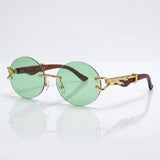 Round rimless sunglasses with gold feline side accent
