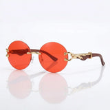 Round rimless sunglasses with gold feline side accent