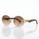 Round rimless sunglasses with gold feline side accent