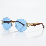 Round rimless sunglasses with gold feline side accent
