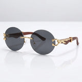 Round rimless sunglasses with gold feline side accent