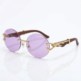 Round rimless sunglasses with gold feline side accent
