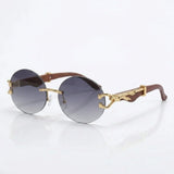 Round rimless sunglasses with gold feline side accent